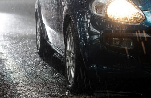 car in rain at night