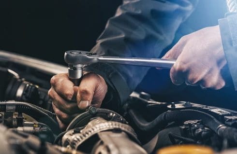 mechanic fixing a cars gears