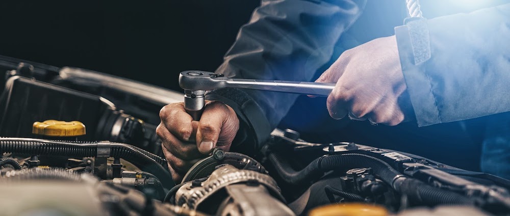mechanic fixing a cars gears